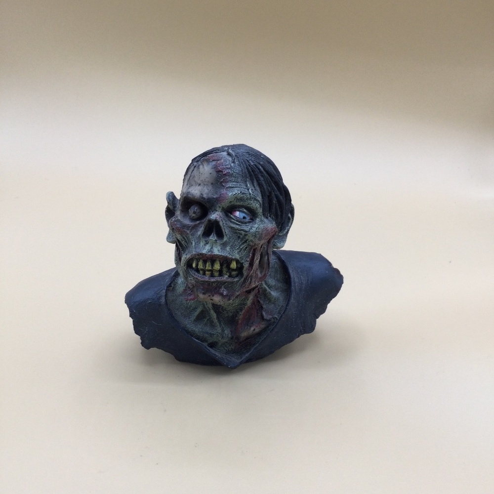 Gruesome zombie head statue